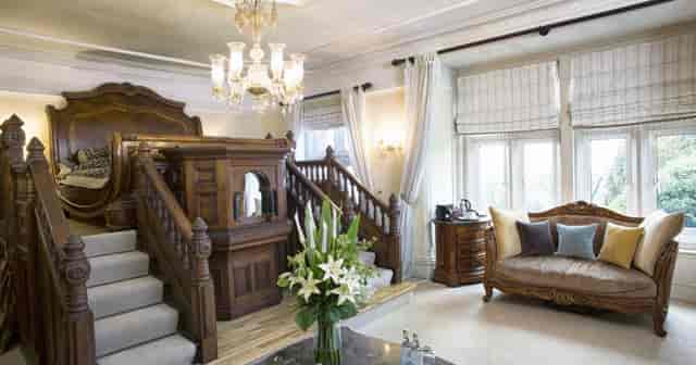 Elegant meeting space at Berwick Lodge with ornate staircase, ideal for gatherings.
