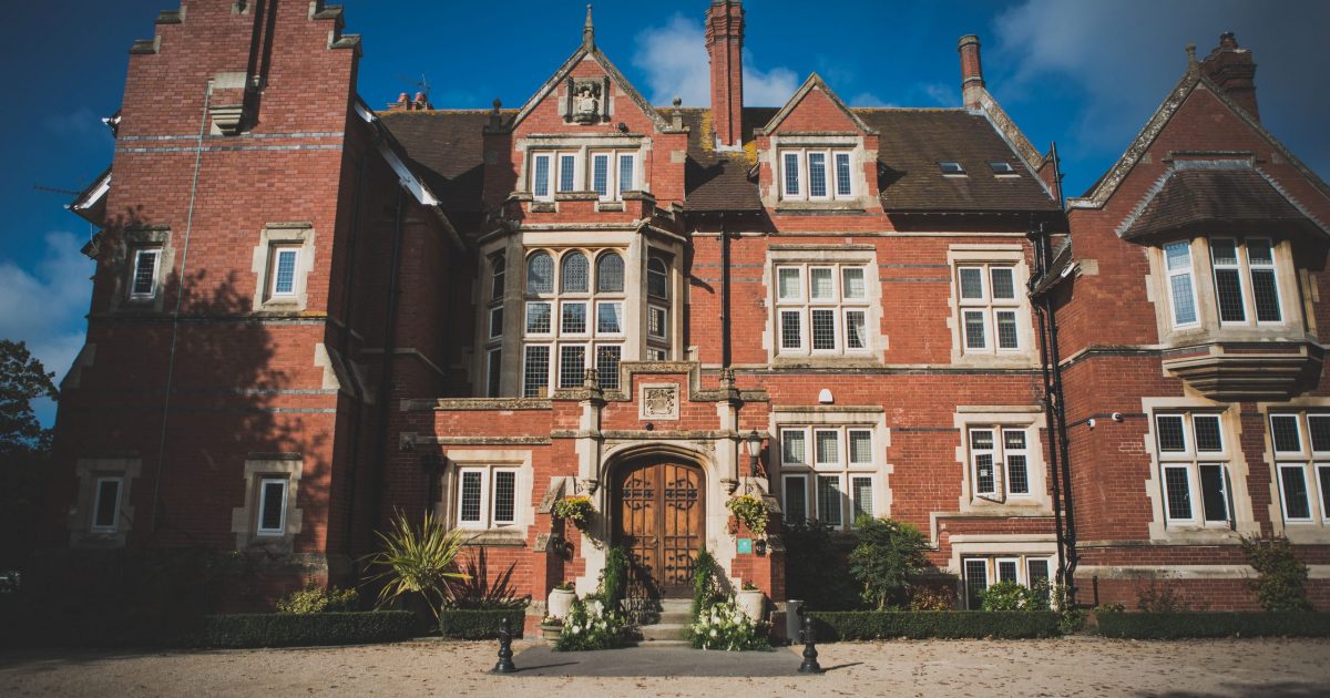Elegant red-brick mansion at Berwick Lodge, perfect for upscale weddings and corporate events. - Banner