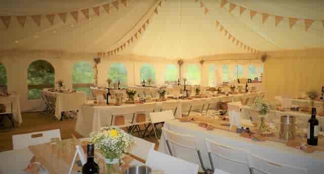 Tented wedding venue at Beeses Riverside Bar with elegant decor and soft lighting.