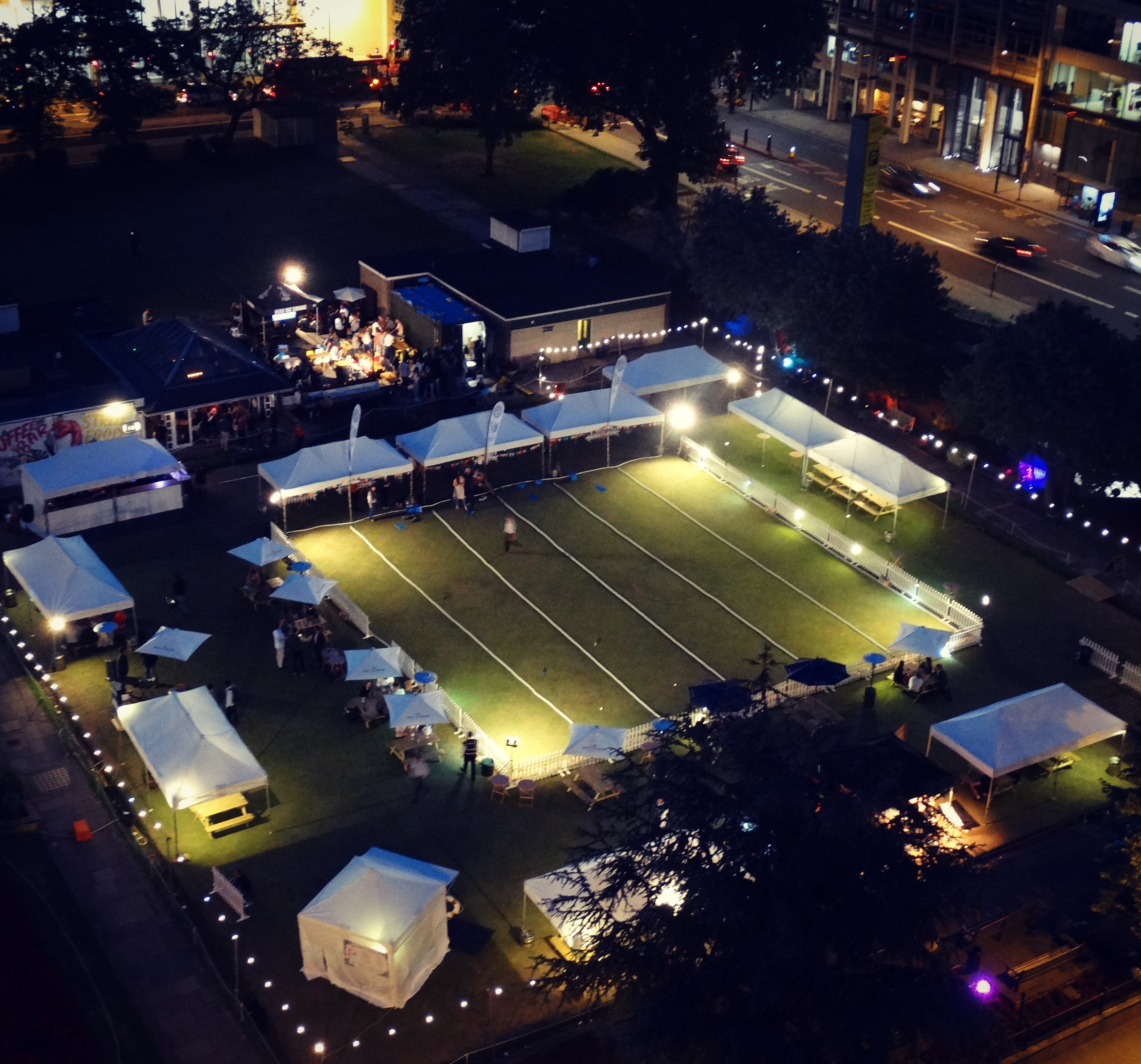 Outdoor event space at Festibowl with tents, ideal for gatherings and networking. - Banner