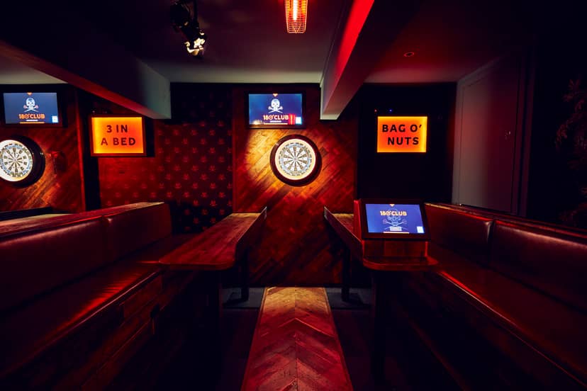 Stylish darts event space with cozy seating for team-building and networking activities.