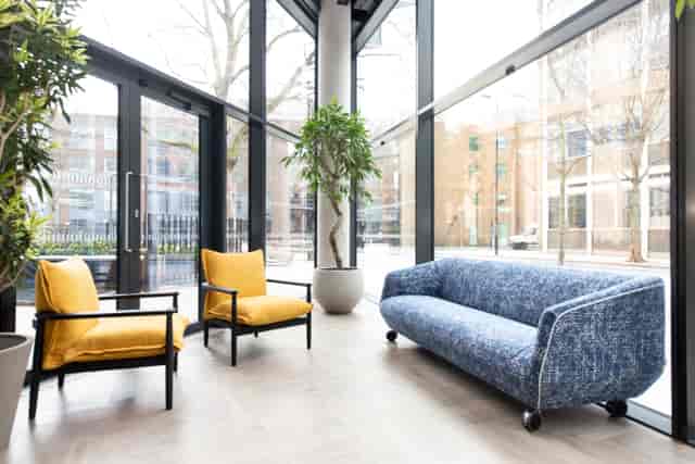 Modern lounge area with yellow chairs for networking at FORA-Southwark event space.