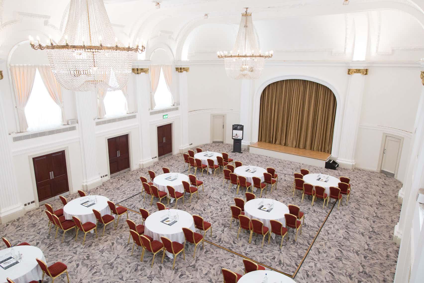 Spacious Mercure Grand Bristol ballroom set for corporate meeting with elegant decor.