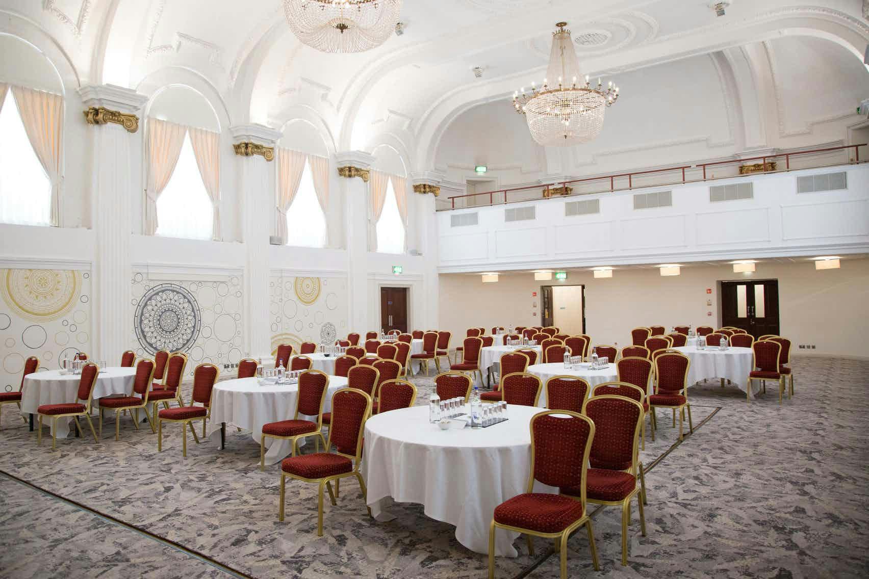 Elegant ballroom with round tables, ideal for weddings and conferences at Mercure Grand Bristol.