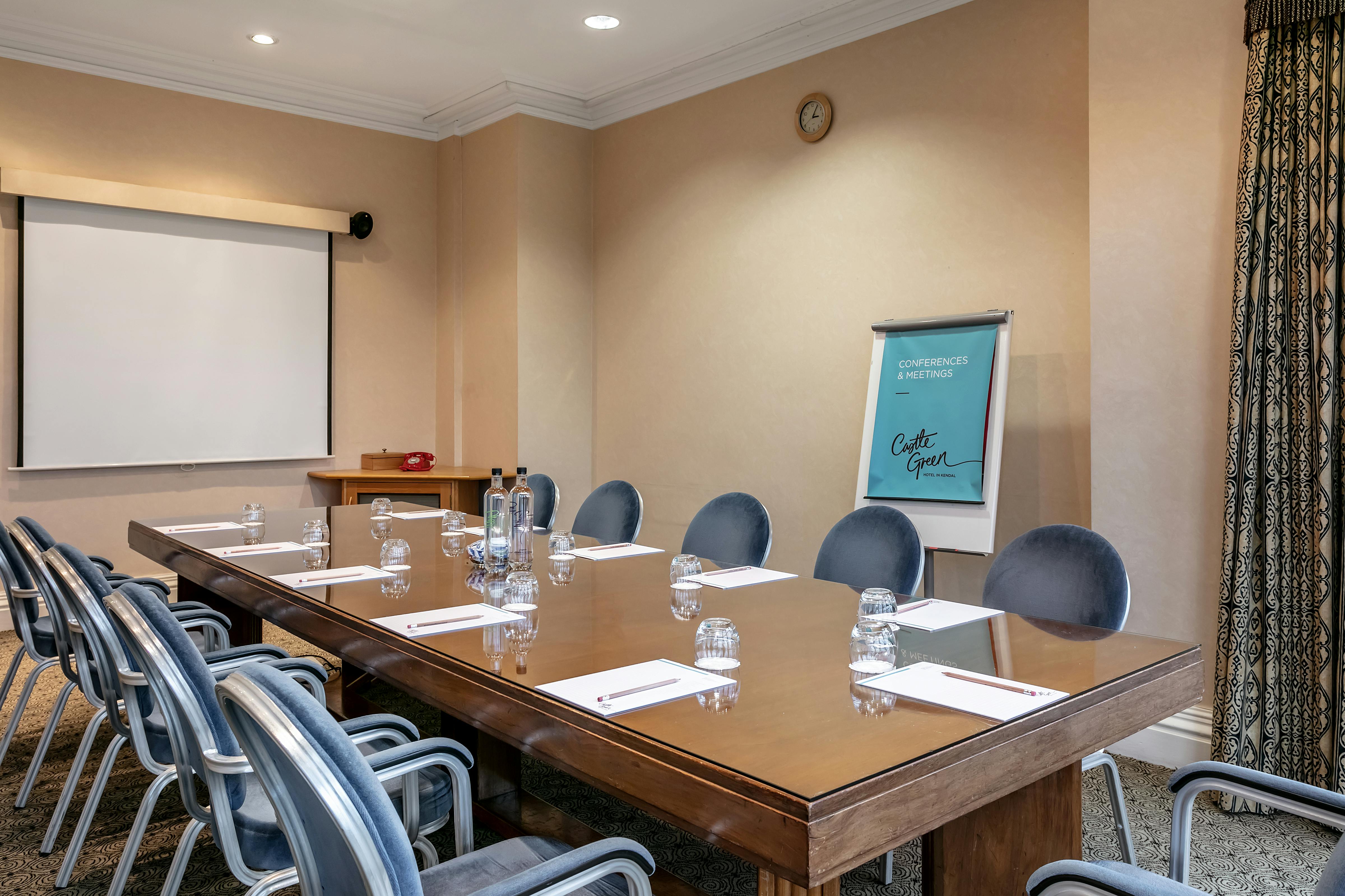 Castle Room at Castle Green Hotel, featuring a long wooden table for professional meetings.