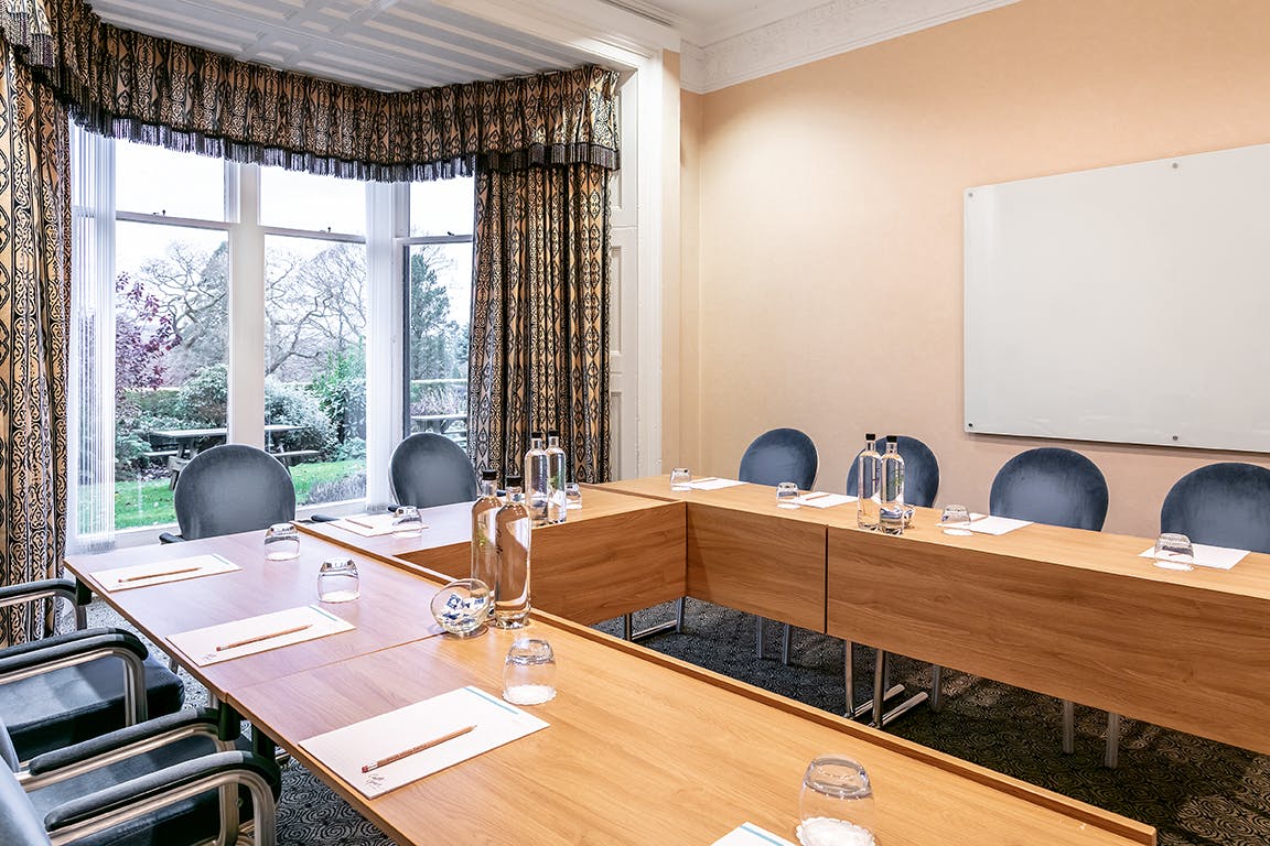 Board Room at Castle Green Hotel with long wooden table, ideal for meetings and events.