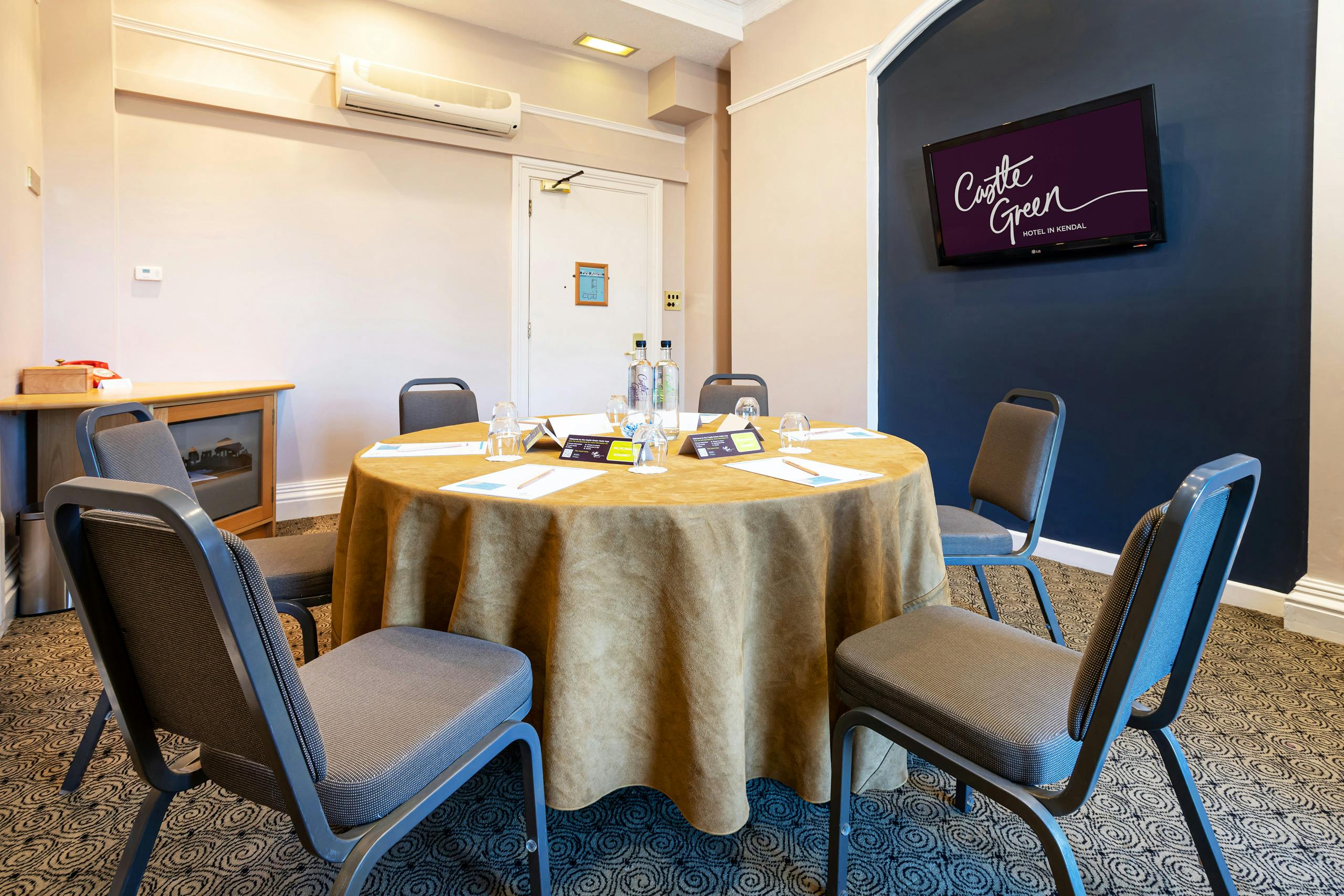 Bindloss Room at Castle Green Hotel: modern meeting space with round table for events.