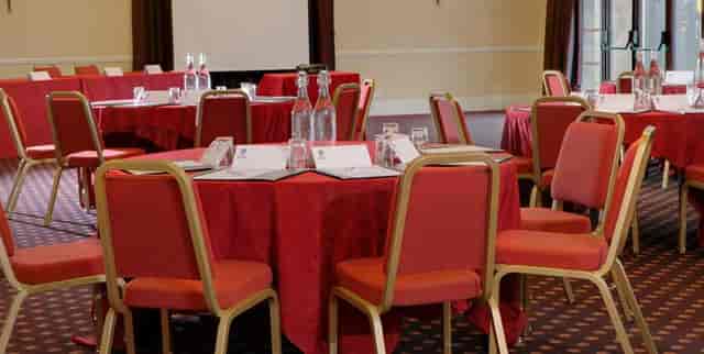 Bristol Suite meeting space with round tables, ideal for workshops and conferences.