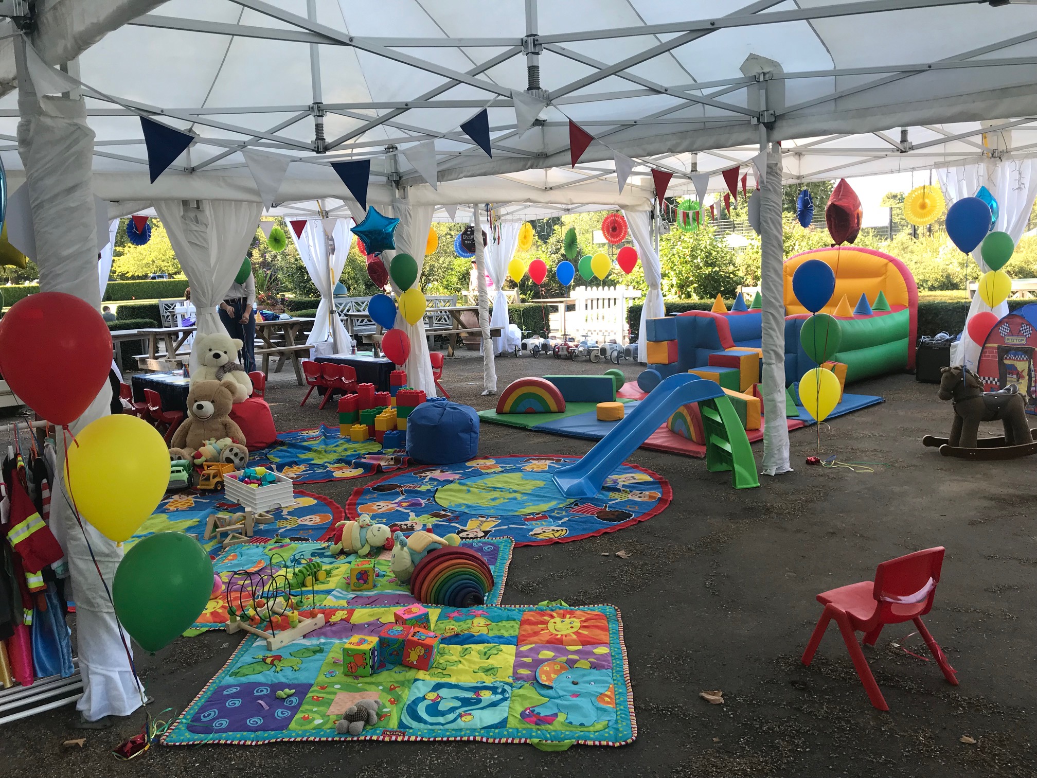 Colorful children's event space with bouncy castle for birthday parties in Hyde Park. - Banner