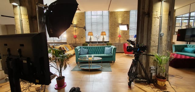 The New Yorker Gallery event space with teal sofa, ideal for video shoots and meetings.