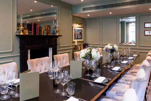 Private dining room at The Curio Lounge with velvet seating for corporate dinners and meetings.