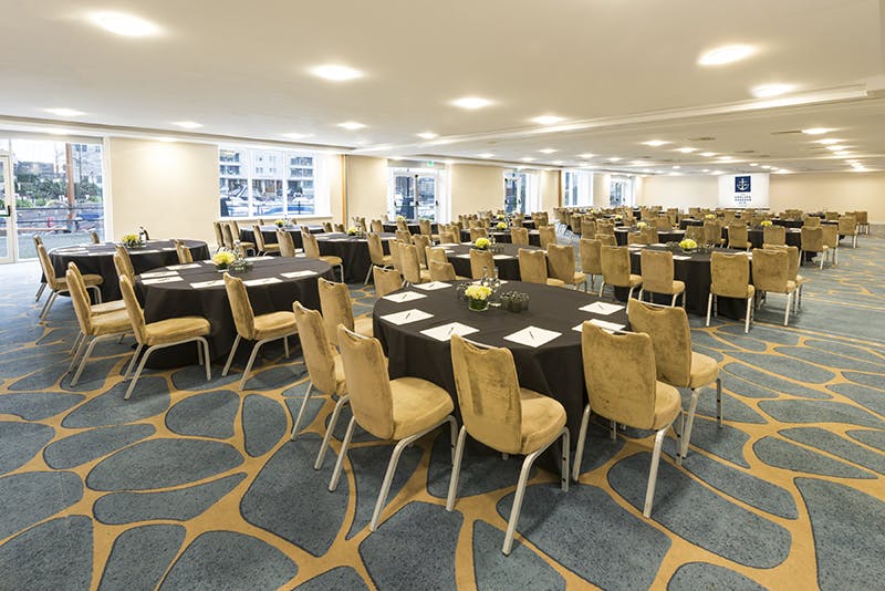 Grand Room 2 at Chelsea Harbour Hotel, elegant meeting space with round tables for conferences.