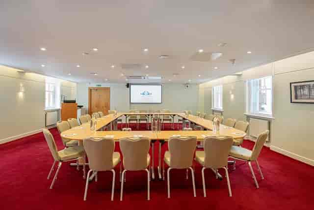 Elegant U-shaped boardroom for corporate meetings & workshops
