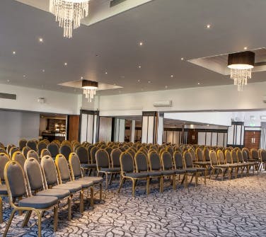 Grand Ballroom at Crowne Plaza Felbridge with elegant chairs for corporate events.