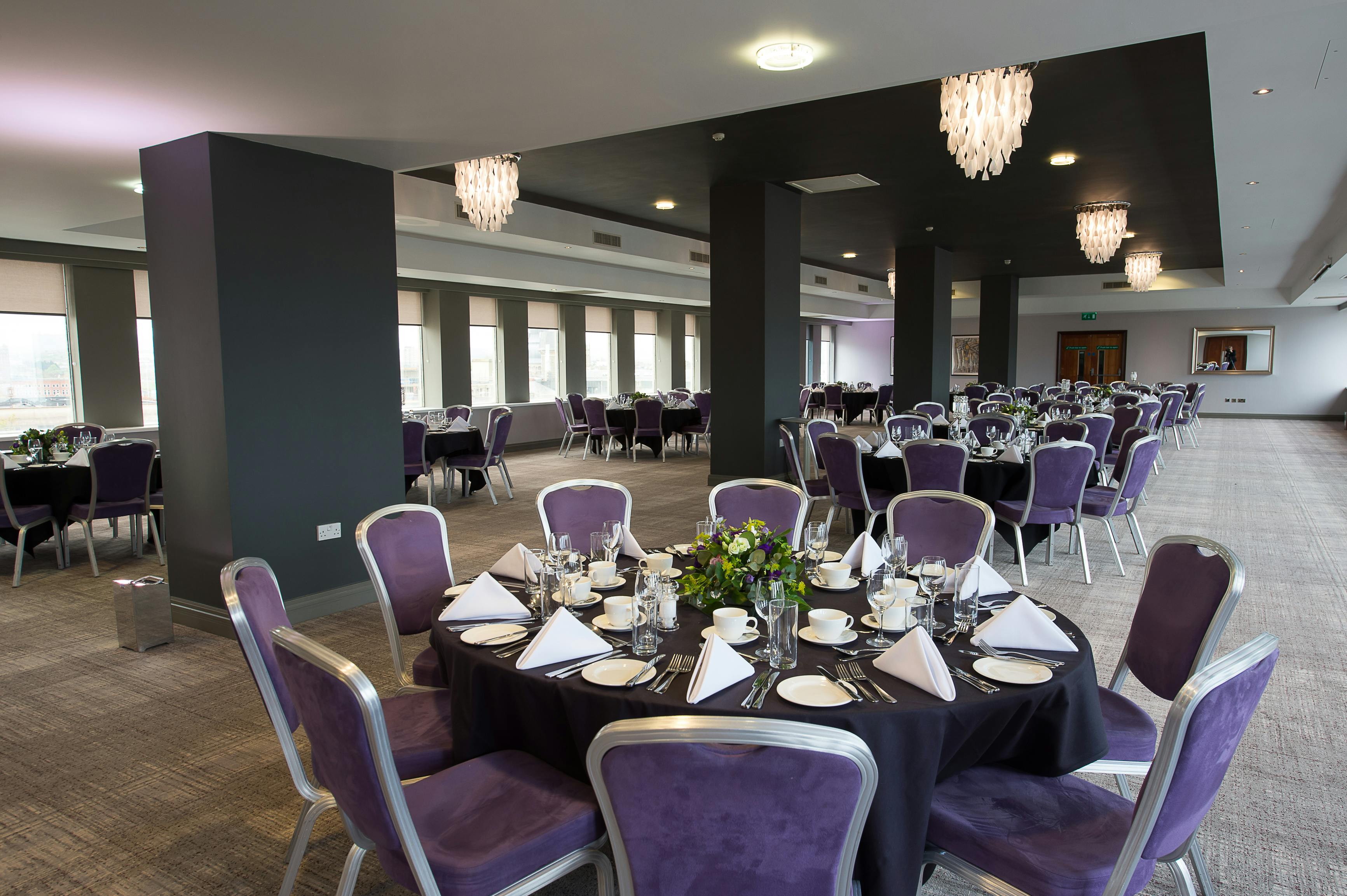 Forest Suite at Mercure Bristol: elegant event space with round tables, ideal for corporate meetings.