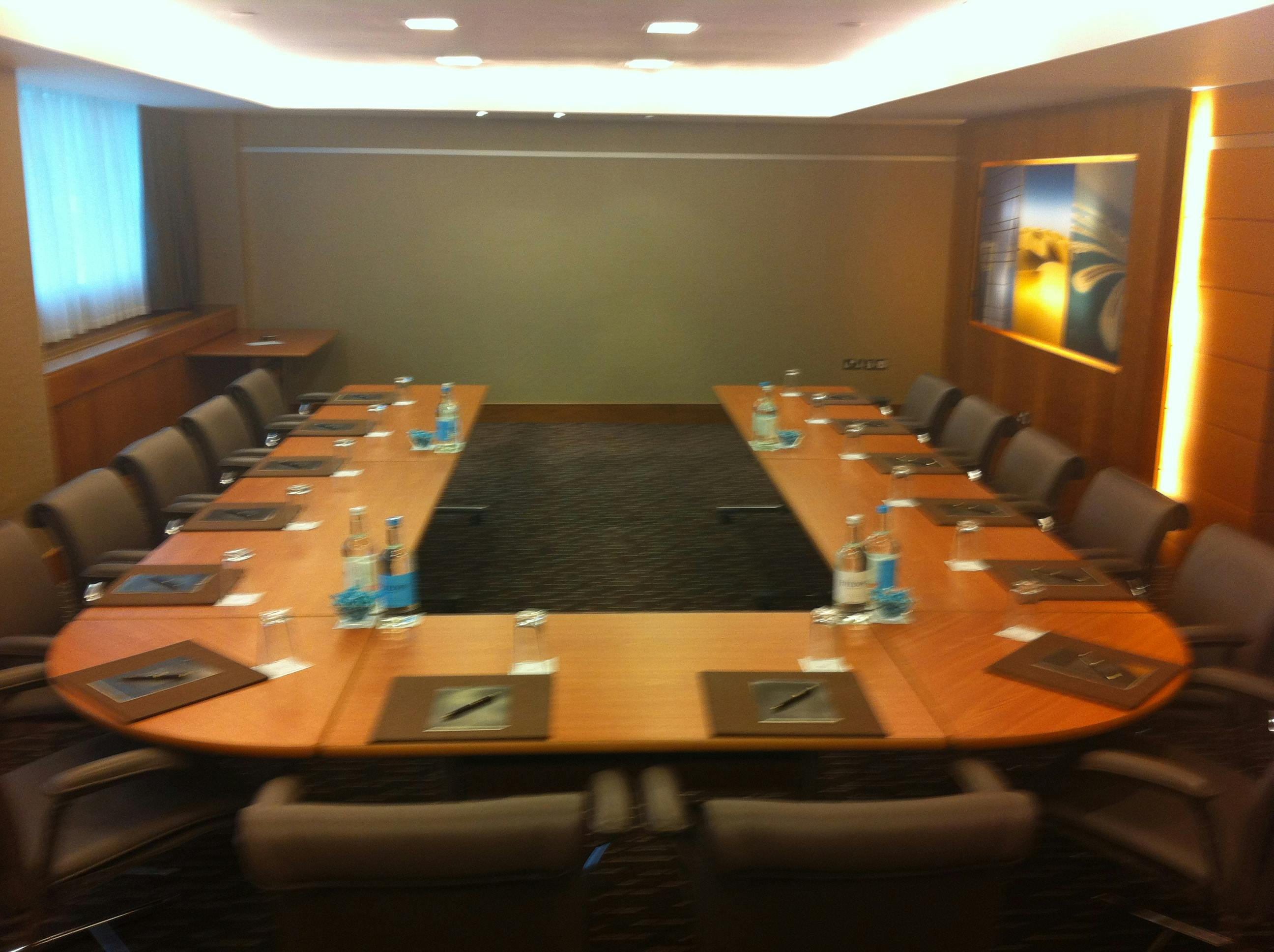 Sofitel London Heathrow meeting room with oval table, ideal for corporate events and meetings.