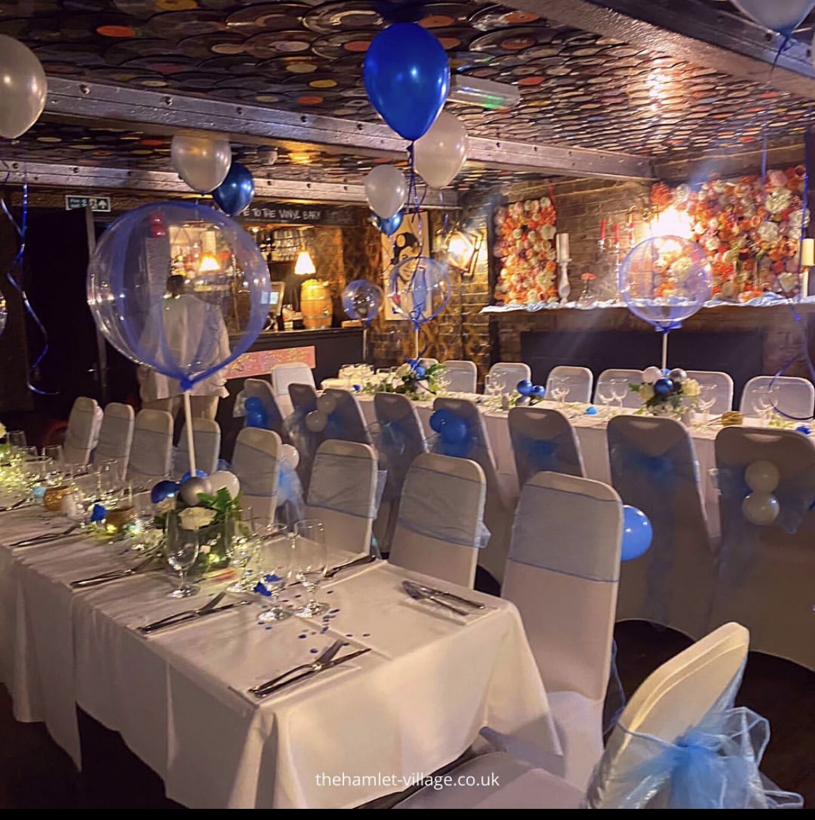 Elegant event space at The Hamlet Vinyl Bar with blue accents and festive decor. - Banner