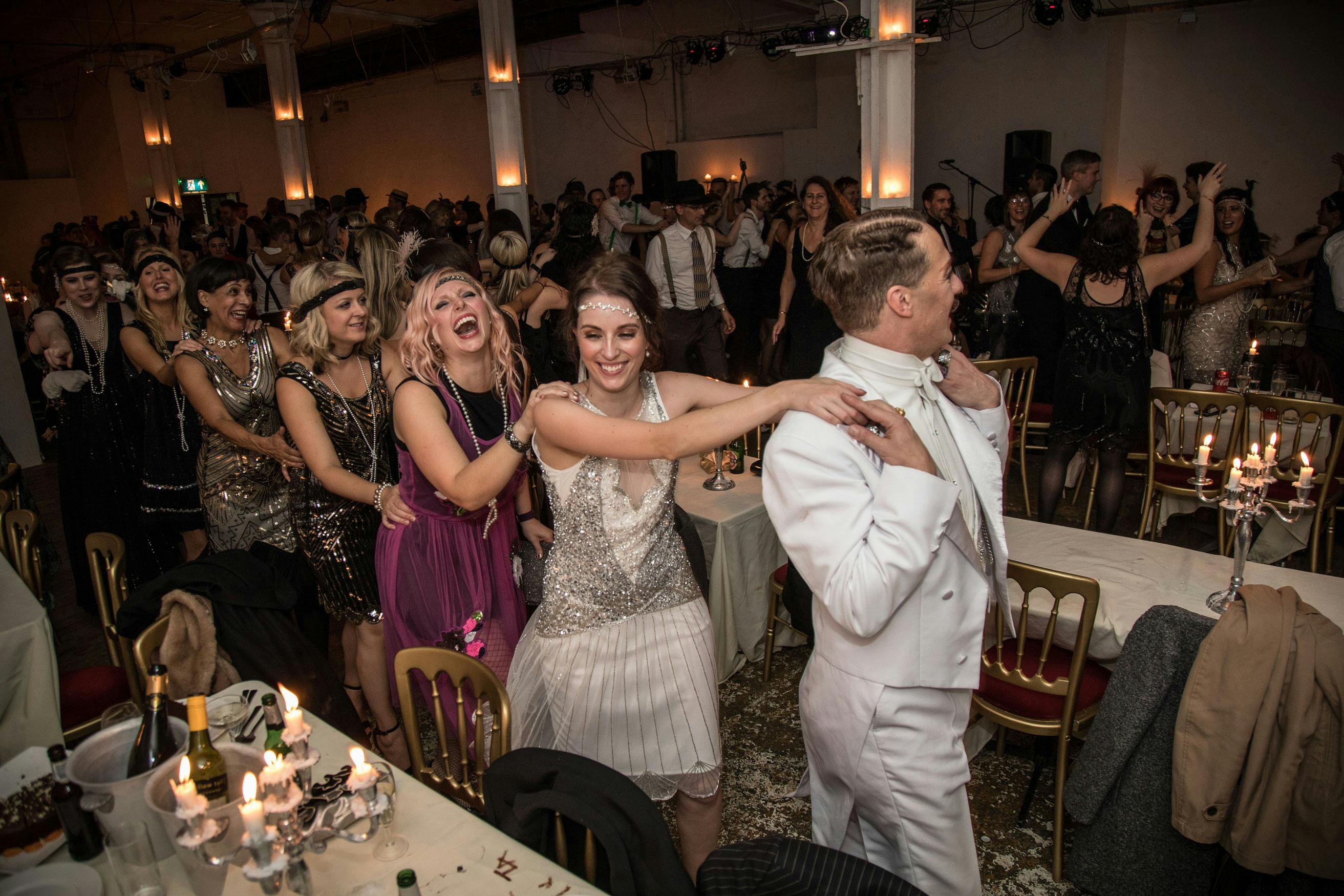 Vibrant dance party at Ground Floor Gallery, elegant decor for wedding or gala celebration.