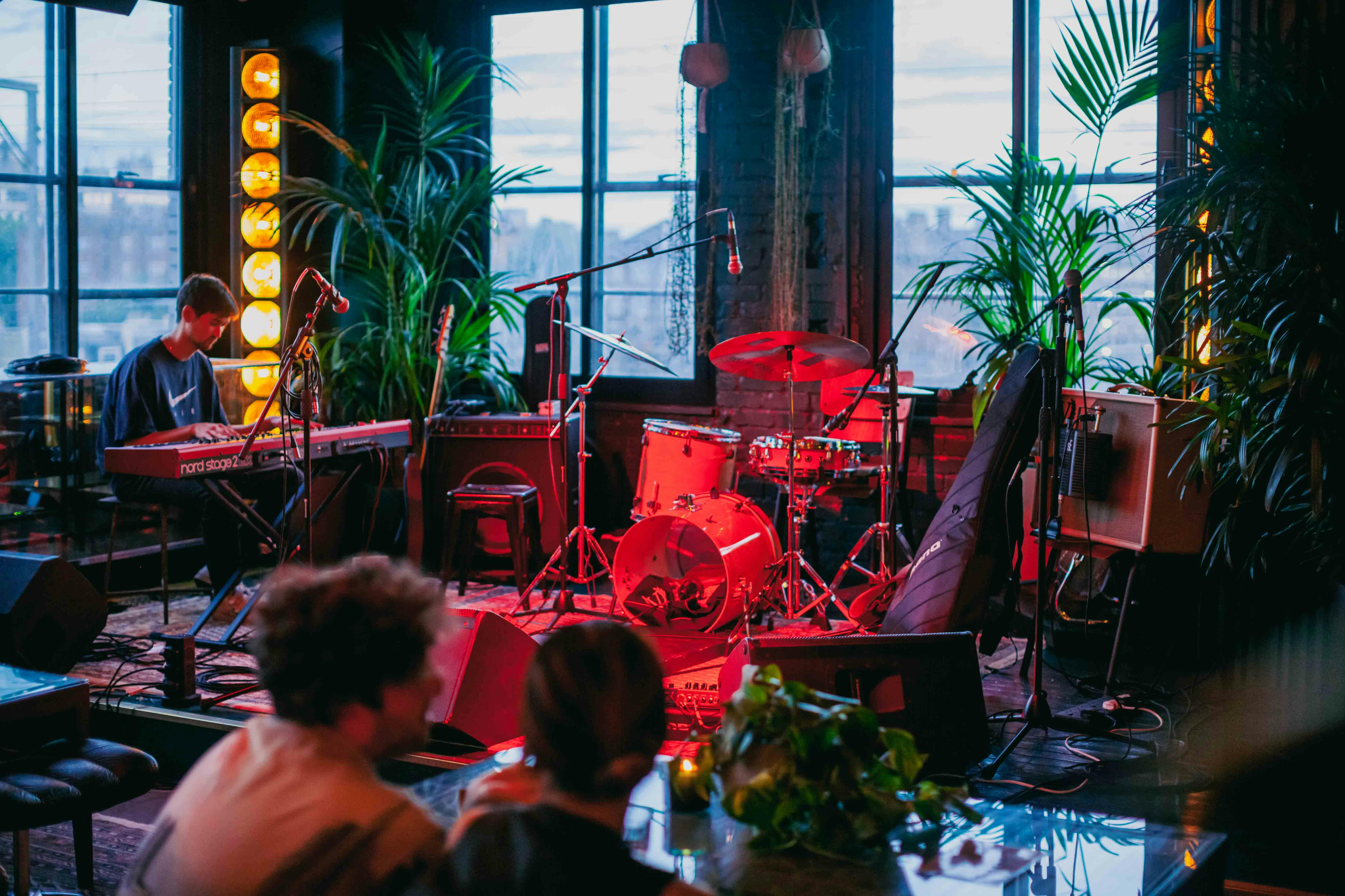 Vibrant event space in NT's Loft for live music, featuring keyboard and drum kit.