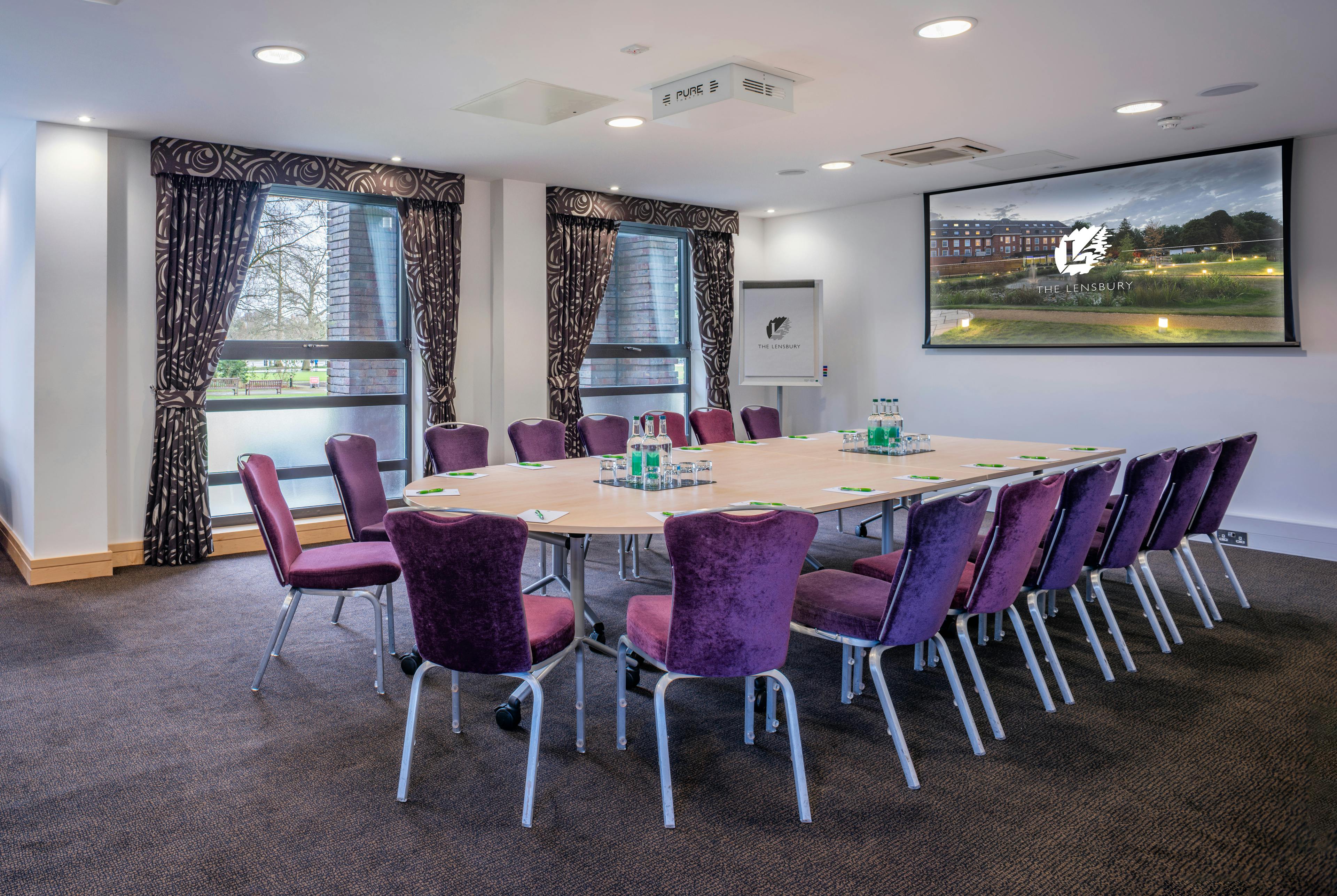 Mortimer Room at The Lensbury: elegant meeting space with plush chairs for professional events.