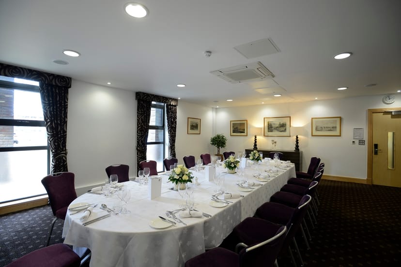 Elegant Lloyd Room dining setup with fine china for corporate events.