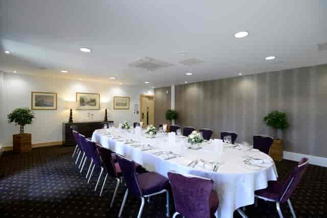 Lloyd Room at The Lensbury: elegant meeting space with plush chairs for corporate events.