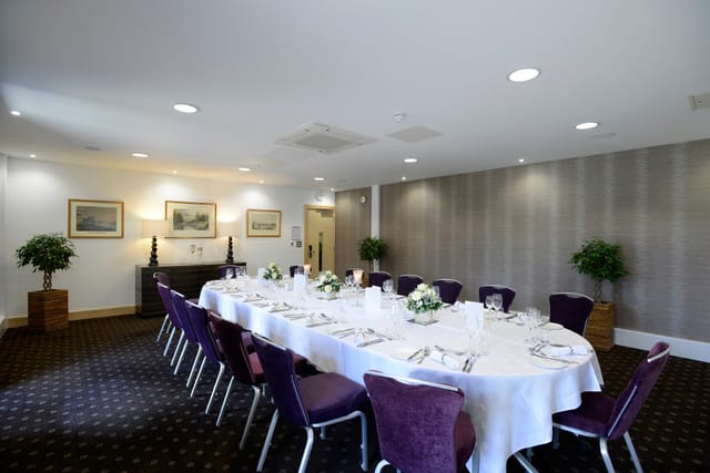 Lloyd Room at The Lensbury: elegant meeting space with plush chairs for corporate events.
