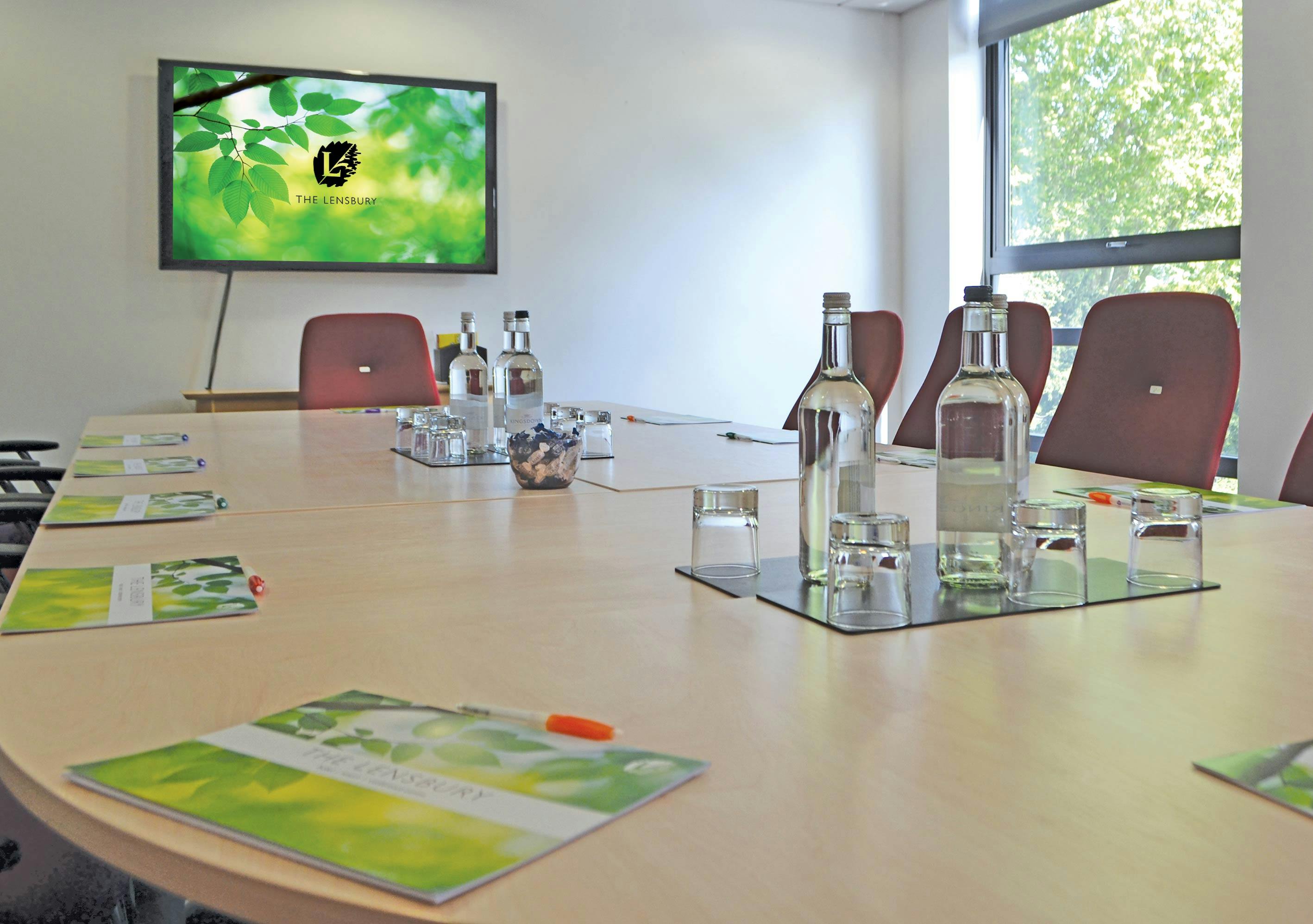 Doherty Room at The Lensbury: oval table, ready for meetings and presentations.