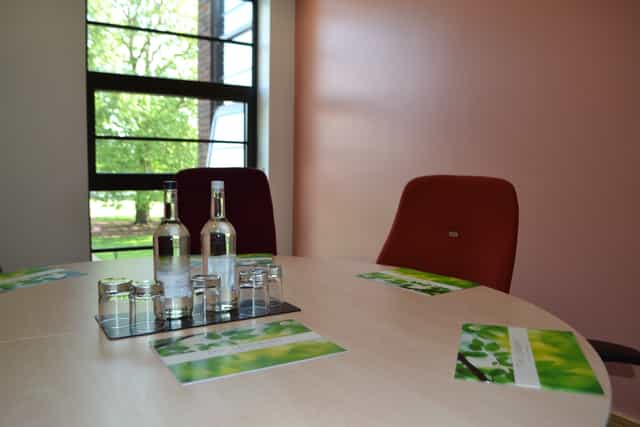 Syndicate Rooms at The Lensbury: round table meeting space with natural light.