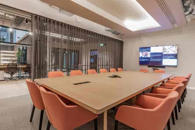 Modern conference room with large screen, ideal for corporate events and meetings.