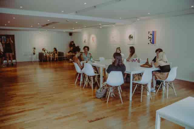 Modern reception area with attendees discussing, perfect for workshops and networking events.