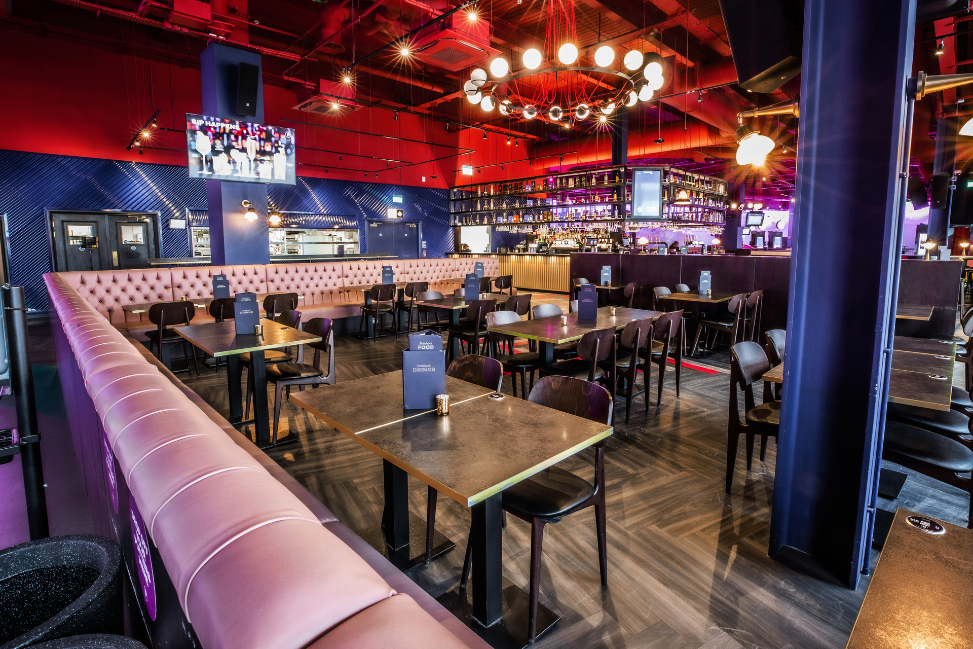 Ruby semi-private event space at Puttshack Lakeside with flexible seating for gatherings. - Banner