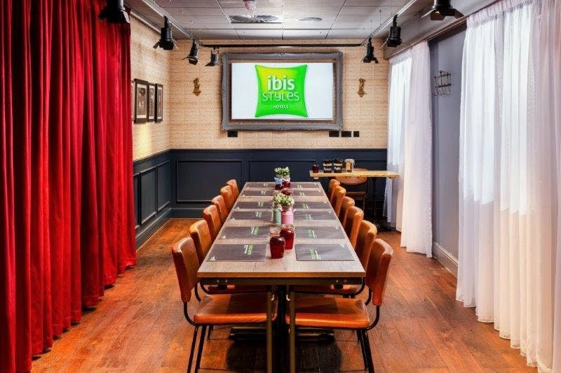 Meeting room at Dickens Club, Ibis Styles Southwark, ideal for workshops and presentations.