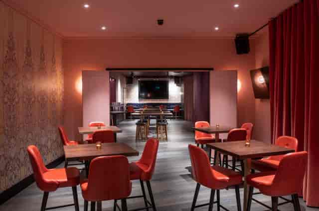 Christmas party at Puttshack Bank with modern decor and warm lighting for networking events.