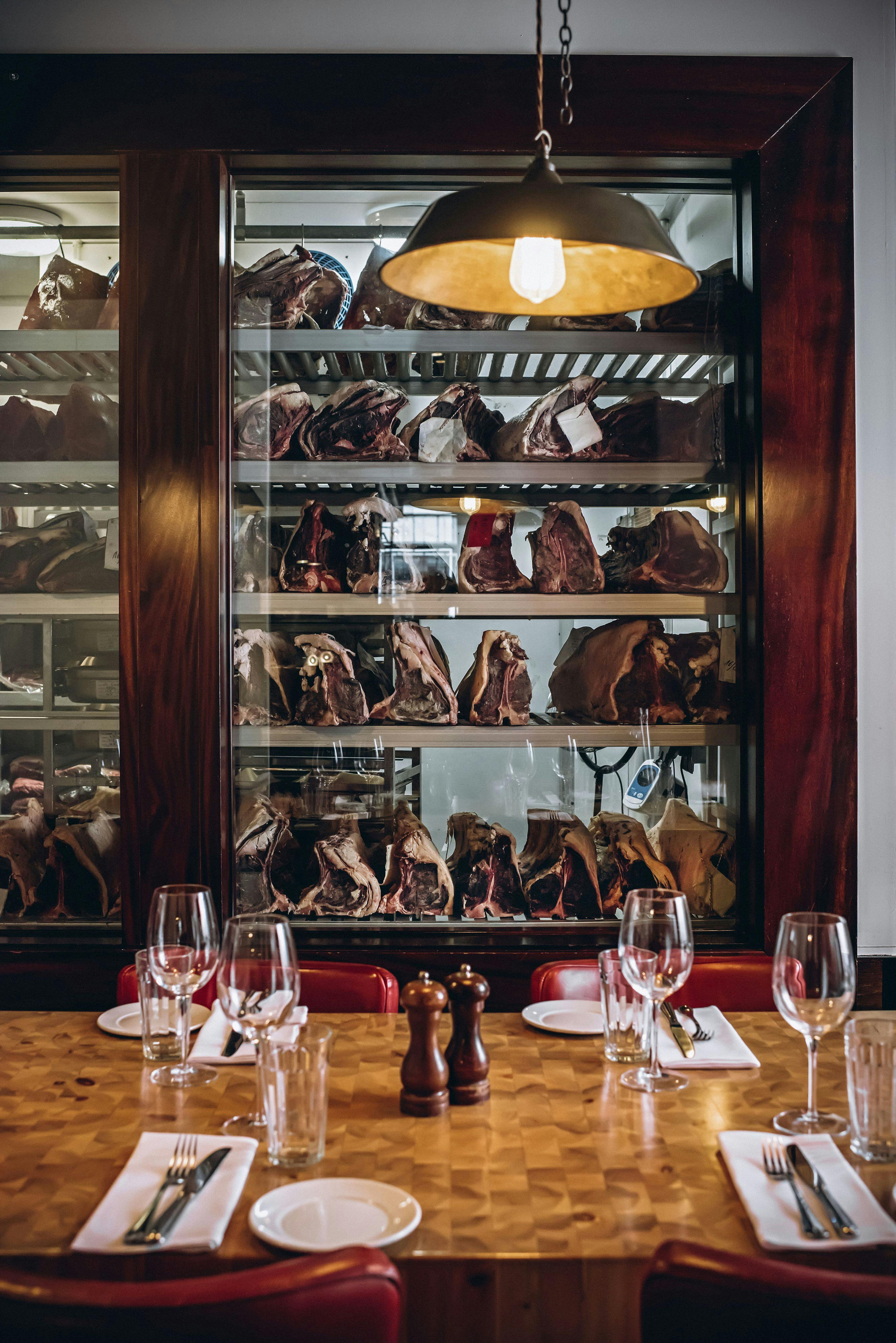 Private dining room with aged meats for upscale corporate events and intimate gatherings.
