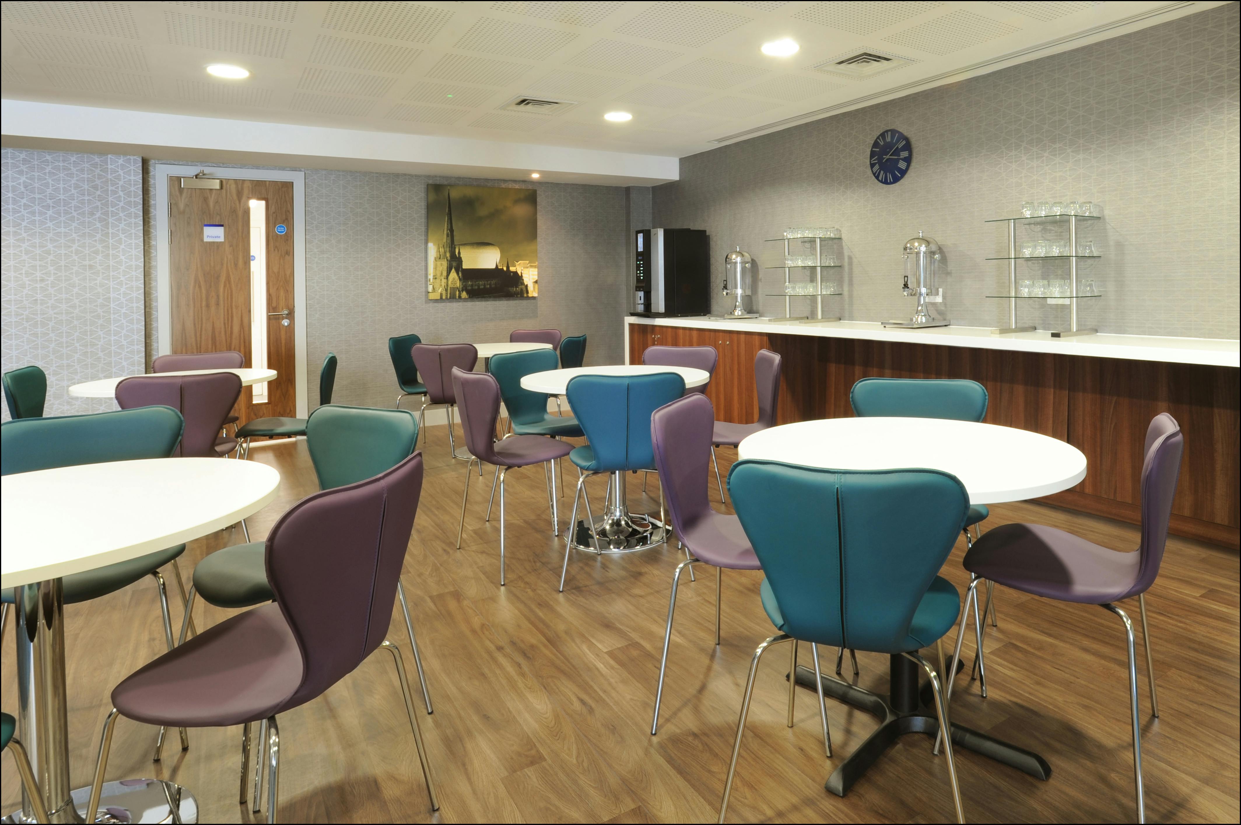 Versatile meeting room with round tables at Holiday Inn Express Birmingham Snowhill.