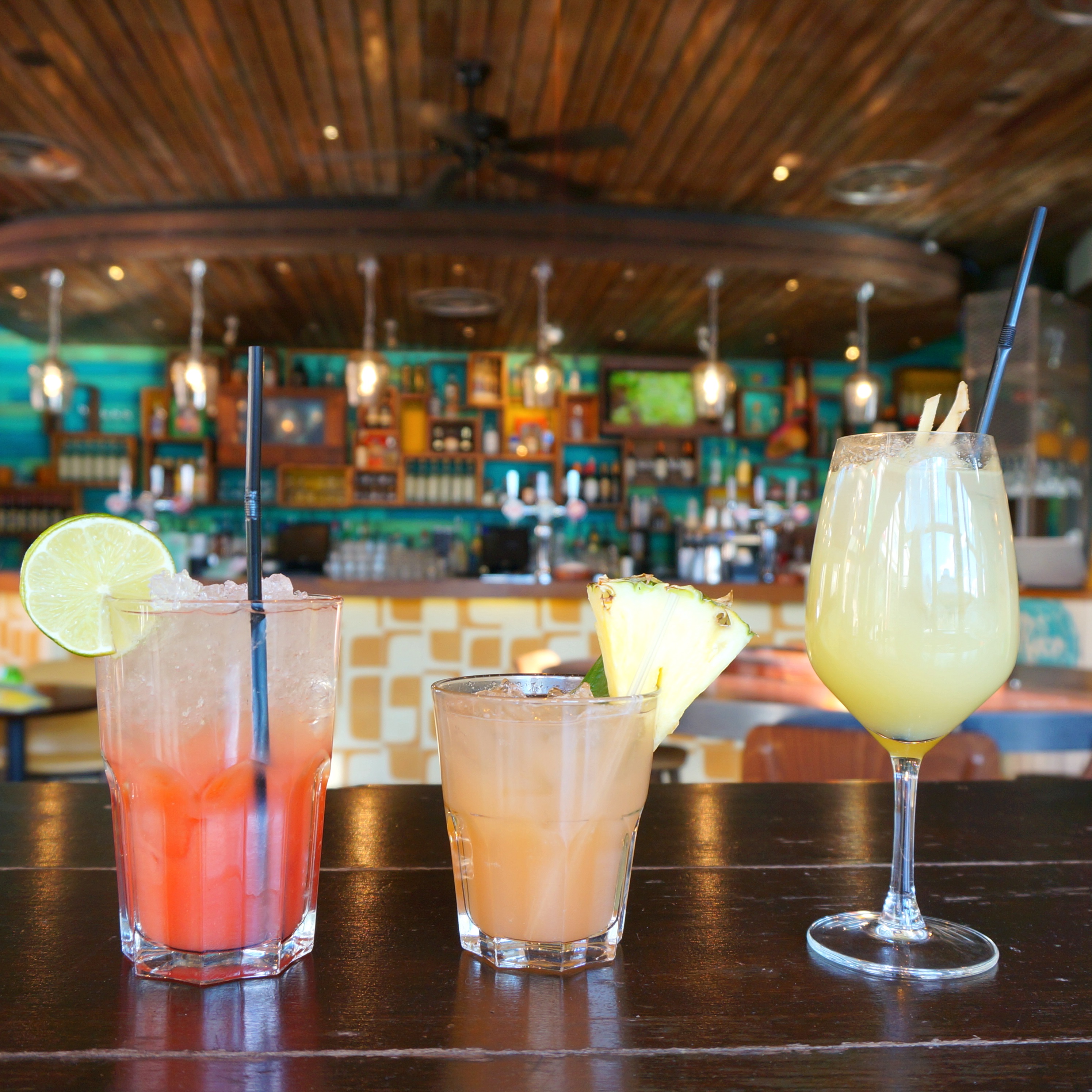 Vibrant bar with colorful cocktails at Las Iguanas for networking events and gatherings.