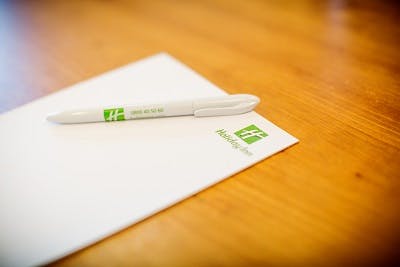 Hampden meeting room at Holiday Inn High Wycombe with branded notepad and pen setup.