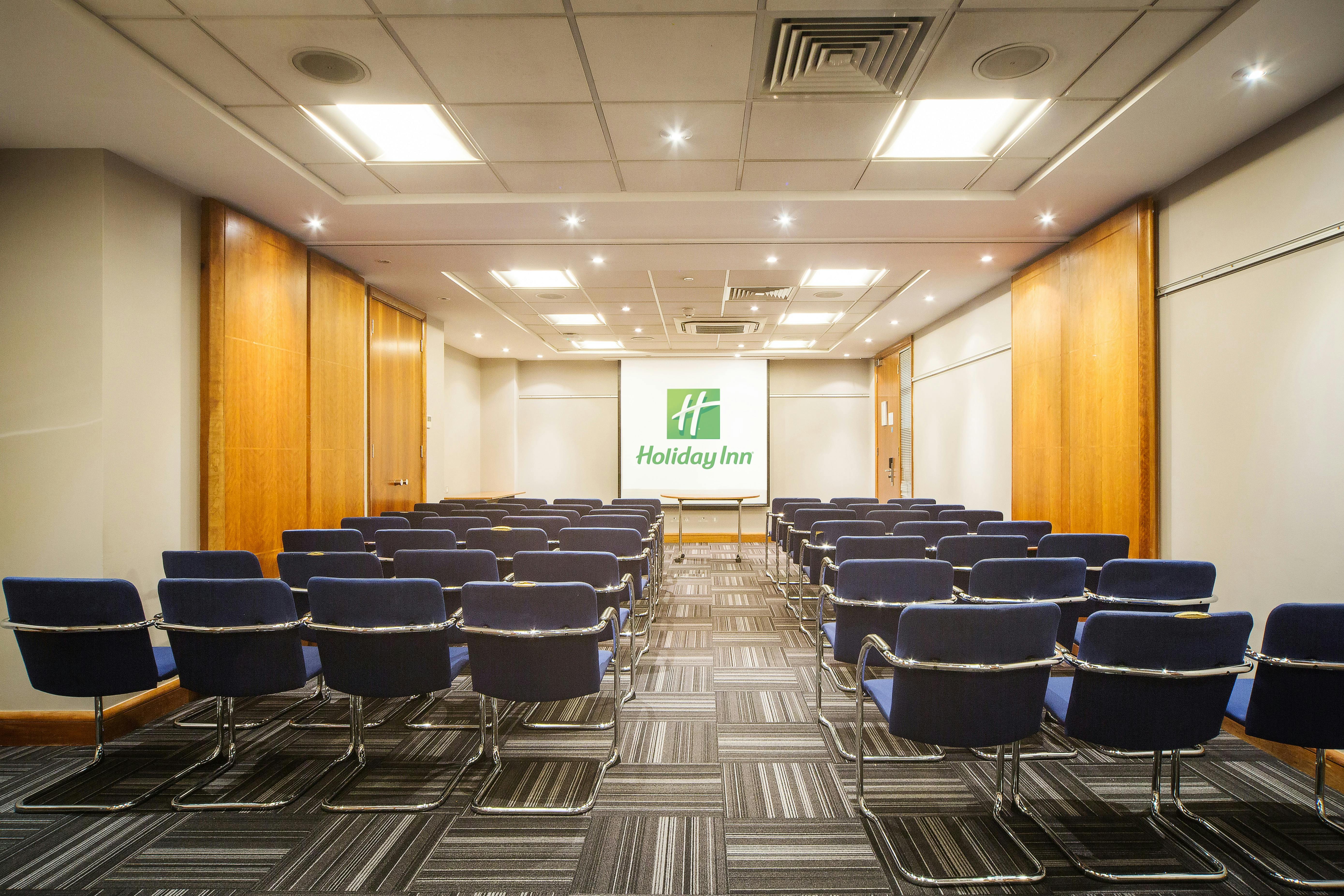 Meeting room at Holiday Inn High Wycombe with blue chairs for corporate events.