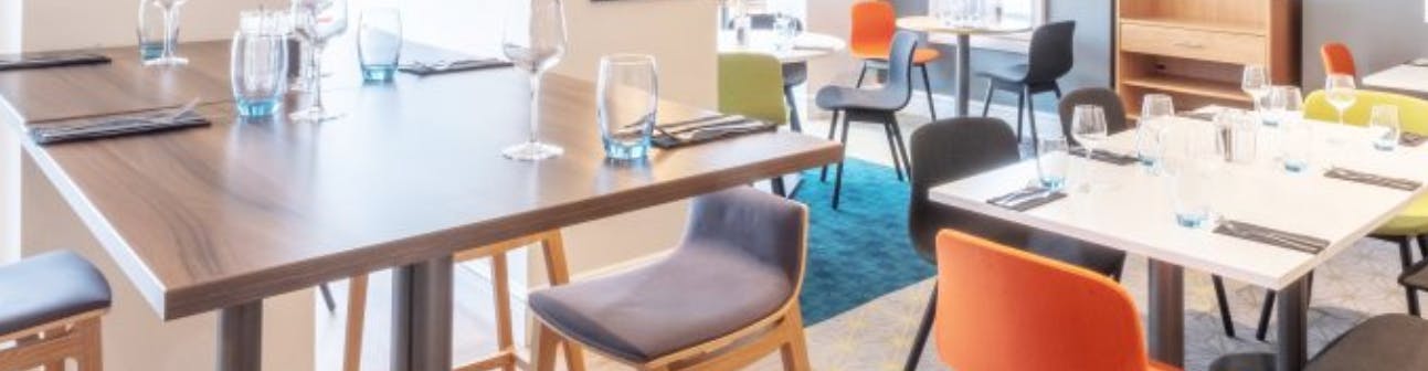 Modern dining setup in Hampshire Suite, Holiday Inn Farnborough for events and meetings.