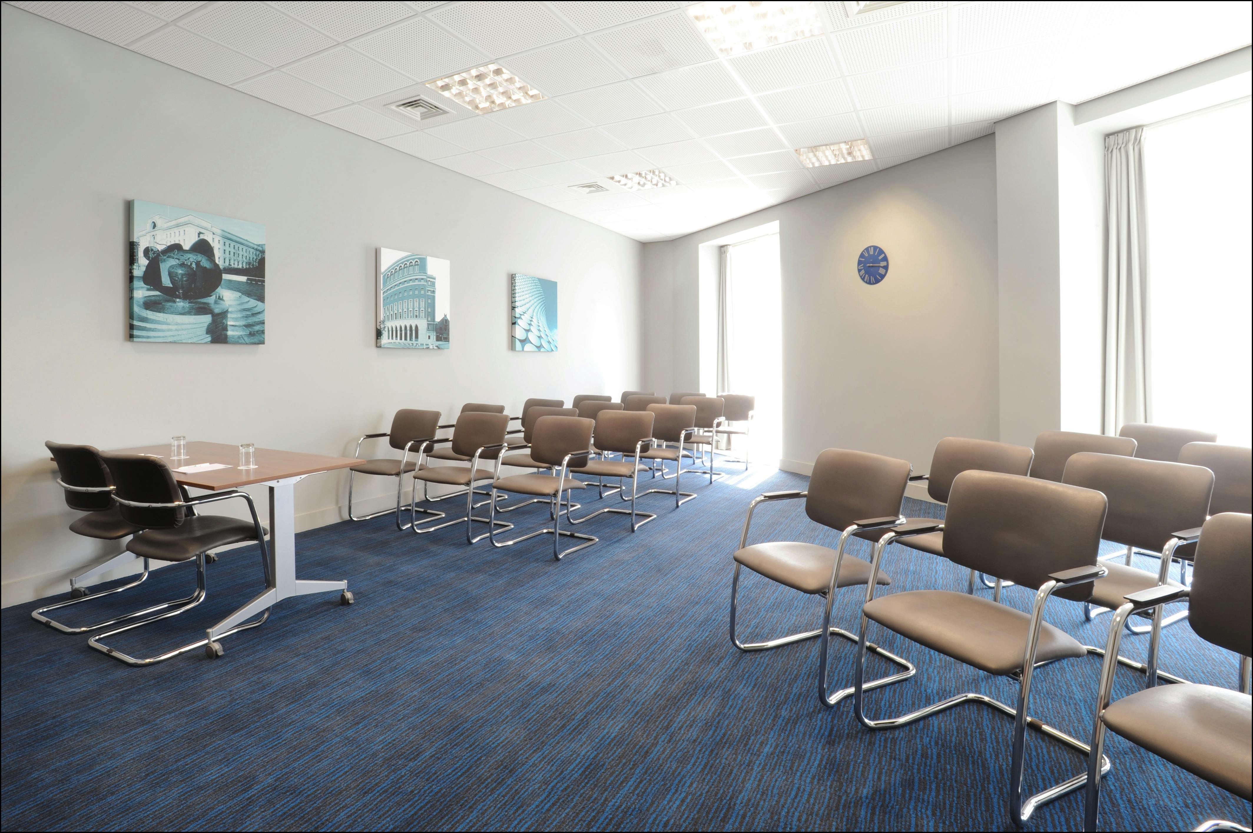 Meeting Room 4 at Holiday Inn Express, featuring modern chairs for workshops and training.