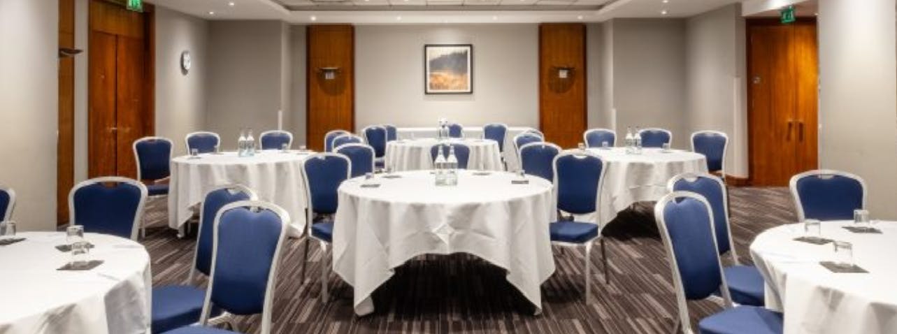 Black Prince Suite meeting room with round tables, ideal for professional events and workshops.