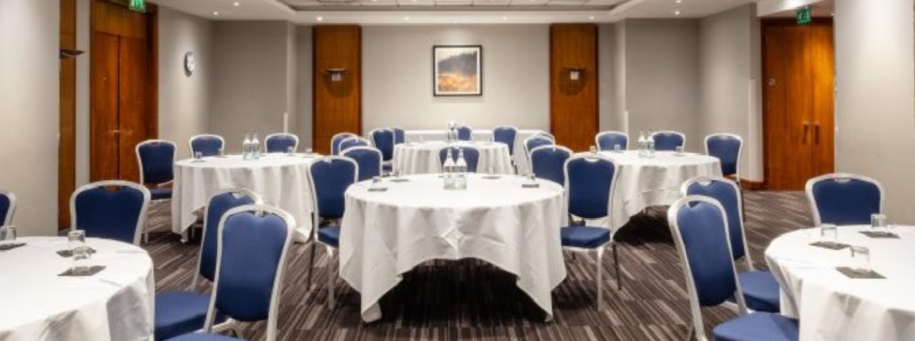 Black Prince Suite meeting room with round tables, ideal for professional events in London.