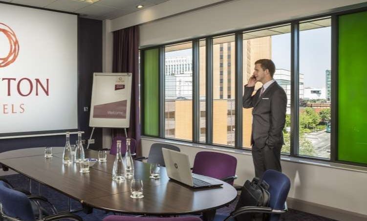 Modern meeting room with sleek table setup for corporate events in Clayton Hotel Cardiff.