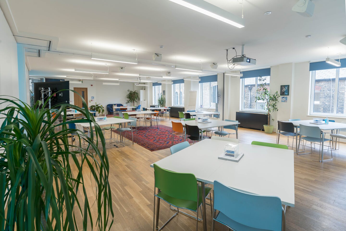 Apollo & Soyuz meeting space with colorful chairs for creative workshops and presentations.