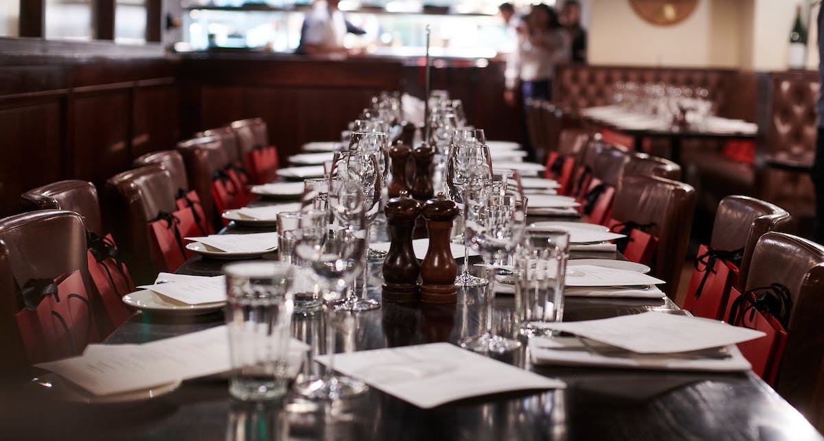 Elegant dining table setup in semi-private space for corporate events and gatherings.