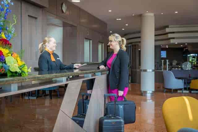 "Welcoming hotel reception at Maldron Hotel Belfast with elegant floral arrangement."