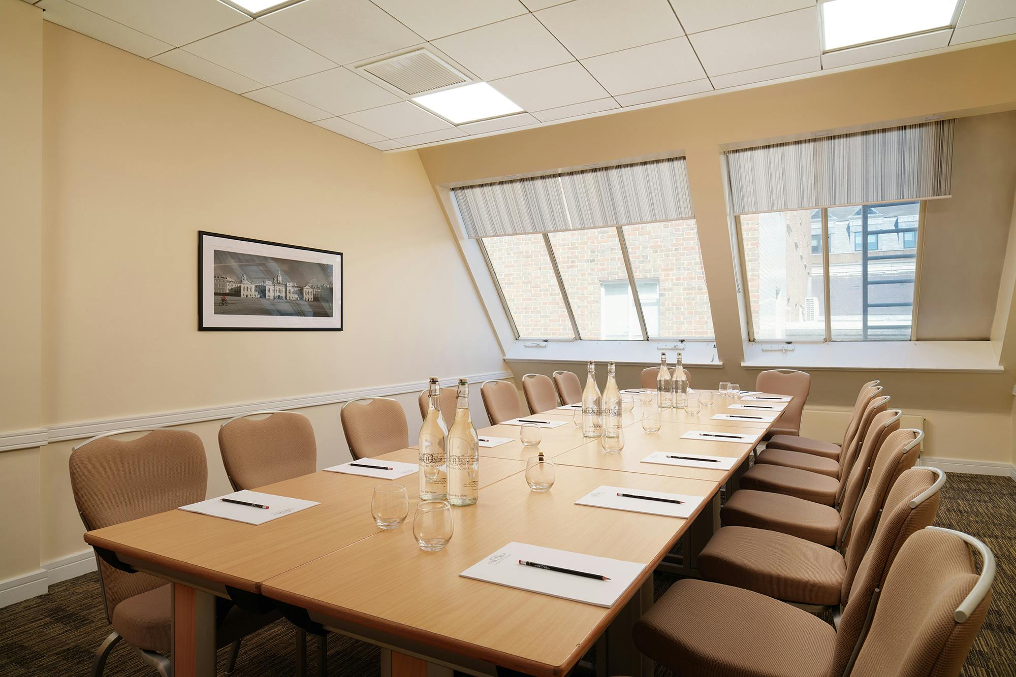 Well-lit meeting room with long table, perfect for corporate meetings and workshops.