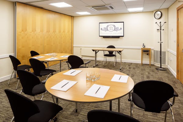 Meeting room at Cavendish Square with circular tables for workshops and presentations.