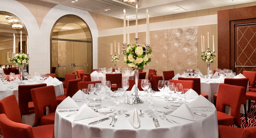 Elegant ballroom with round tables, ideal for upscale events and formal dinners.